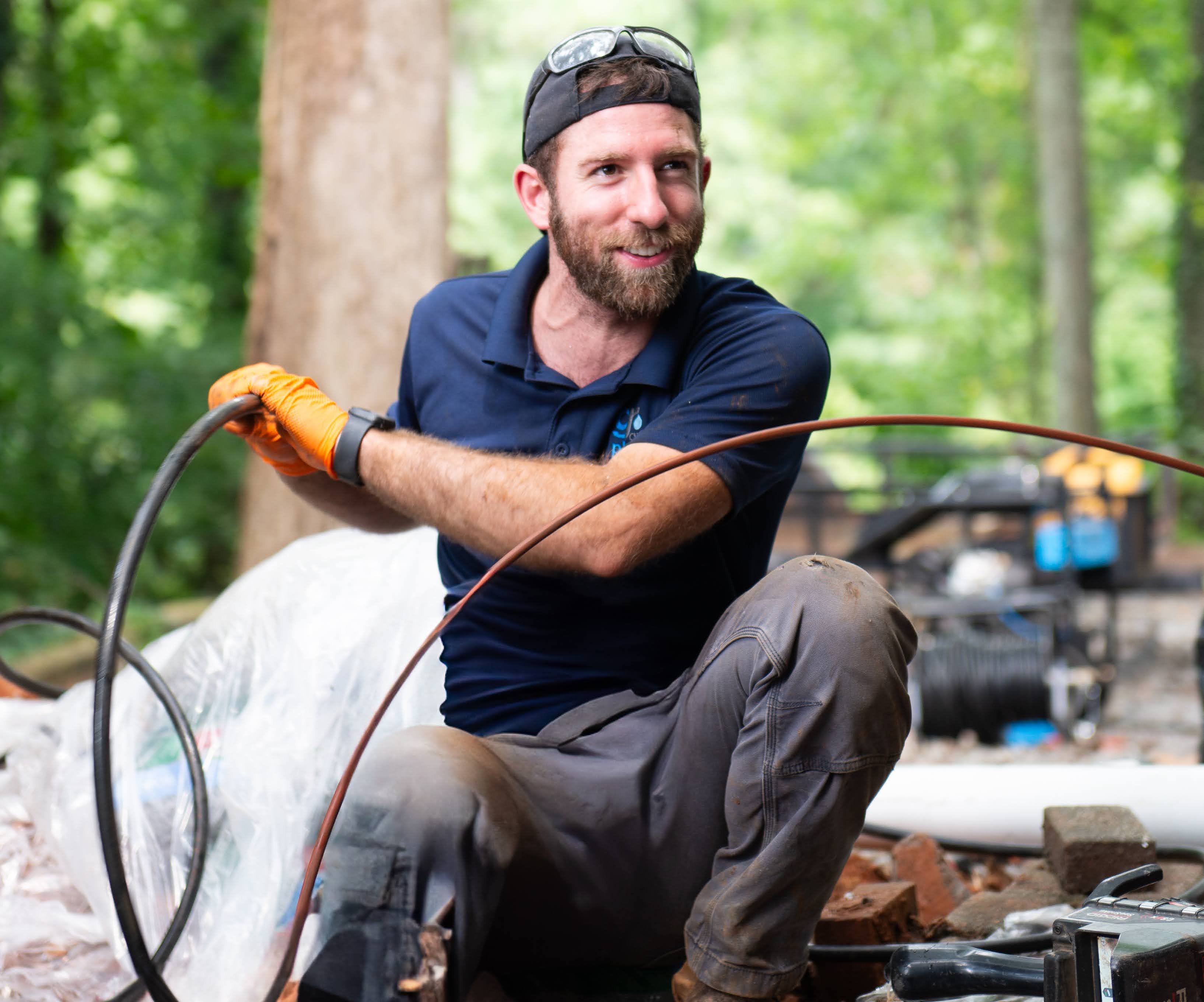 Plumber using a drain cleaning machine