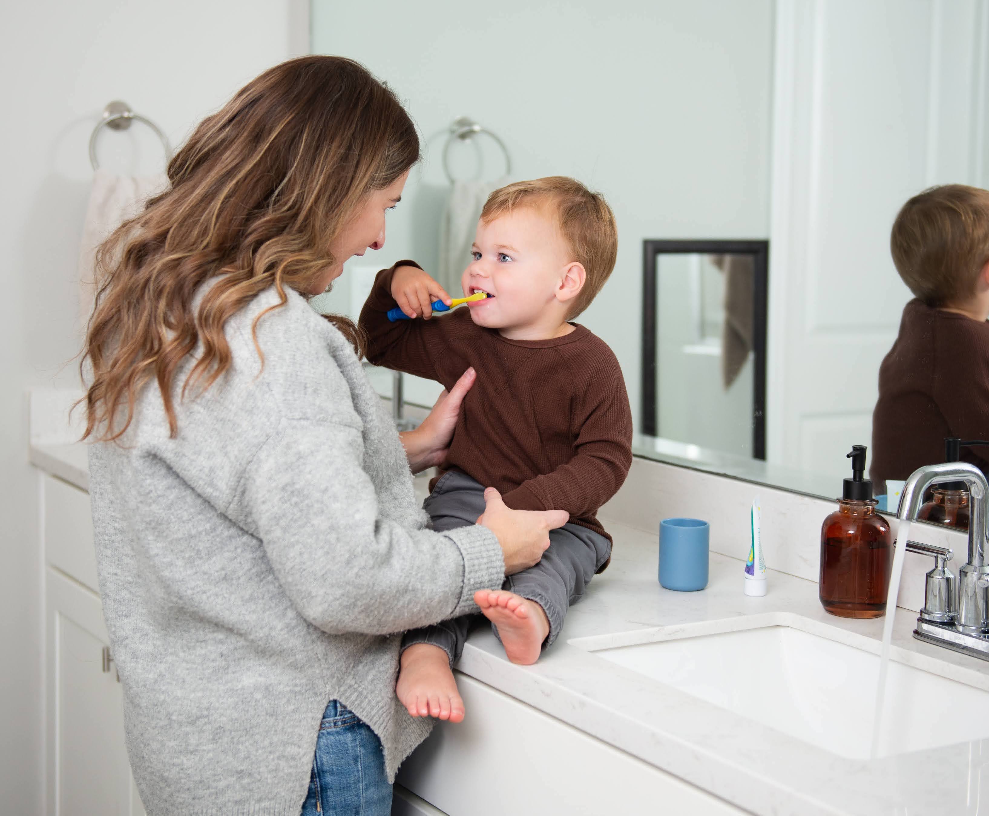 Mom and son brushing teeth in bathroom